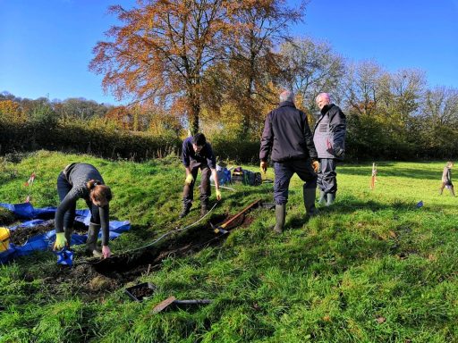 Volunteers measure out the site and start to remove topsoil