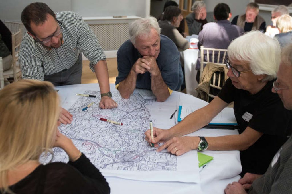 People discussing a map in a workshop