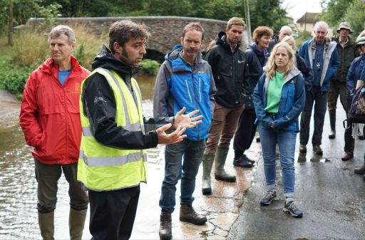 A group of people standing near a ford in the river