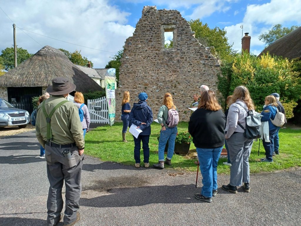 A group of people looking at abbey ruins